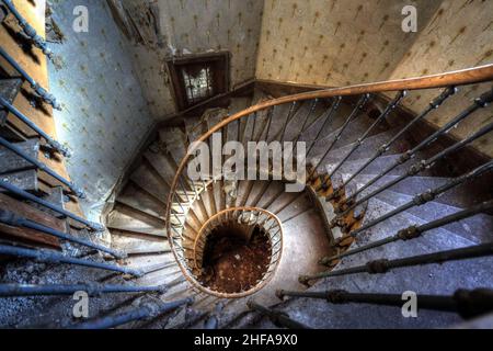 France, February 06, 2016: Spiral staircase in an abandoned villa Stock Photo