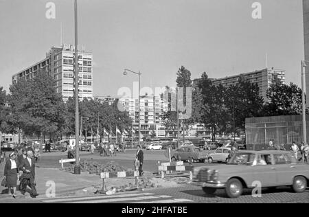 A view across Schouwburgplein of the apartment blocks along Karel Doormanstraat, the (de) Lijnbaan, Rotterdam, the Netherlands in the 1960s. The layout of the residential development, which opened in the late 1950s, separated shops from apartments and were arranged around green courtyards. It was designed by the firm Van den Broek & Bakema led by architects Jo van den Broek and Jacob B (Jaap) Bakema. Today this area completely pedestrianised – a vintage 1960s photograph. Stock Photo