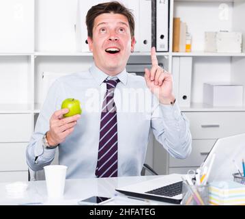 Glad young worker in the office Stock Photo