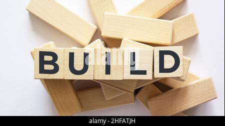 Build word written in wooden cubes and white background Stock Photo