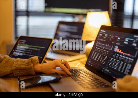 Working on programming dashboard on laptop Stock Photo