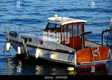 An old type of sport yacht boat anchored in the harbor on a sunny day Stock Photo