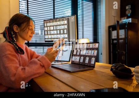 Photographer editing photos at home office Stock Photo