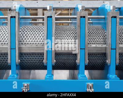 Detail of industrial twin screw press with screens, bridges and locks. Stock Photo