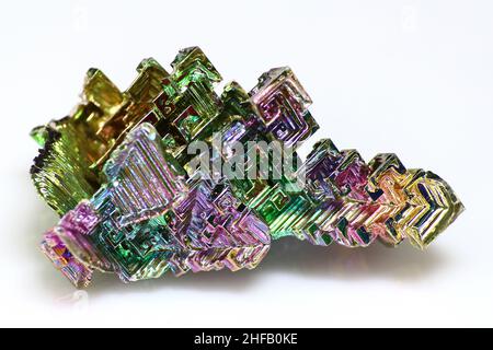 Synthetic bismuth Bismuthum crystal with iridescent oxide film on white background close up isolated Stock Photo