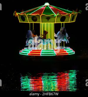 Spinning Illuminated roundabout on the river Derwent in Matlock Bath as part of the Victorian Style Illuminations