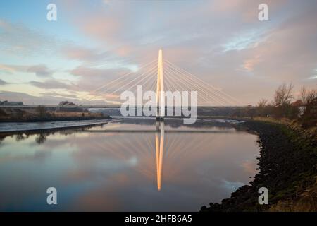 The Northern Spire Bridge opened to traffic in 2018 and crosses the River Wear in Sunderland, Tyne and Wear. Looking up river with cloud reflections i Stock Photo
