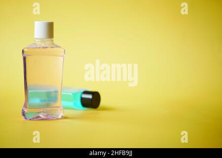 mouthwash liquid in a container on yellow background  Stock Photo