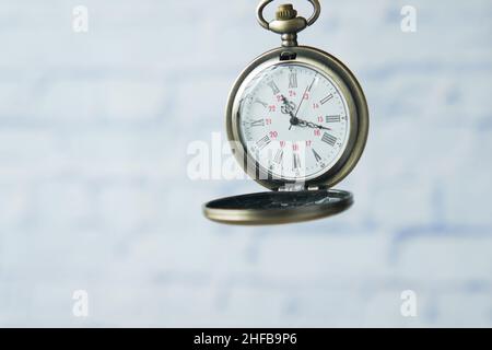 old vintage clock against while wall  Stock Photo