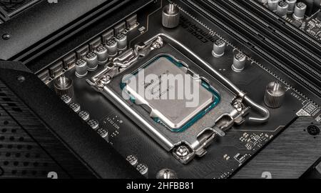 Moscow, Russia - January 12, 2022: Latest Intel i7 12700kf processor chip in socket on motherboard. Intel is one of the worlds largest semiconductor c Stock Photo