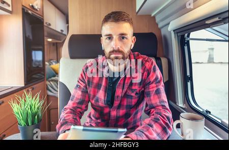 Man on video call from his campervan Stock Photo