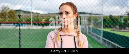 Serious sportswoman with boxer braids posing with crossed arms Stock Photo