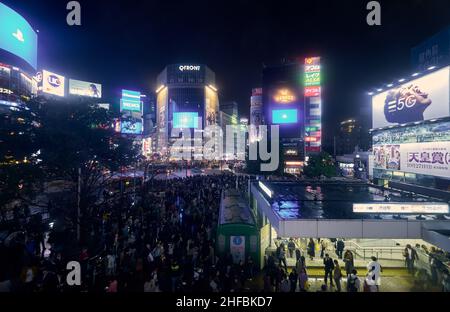 Tokyo, Japan - October 25, 2019:  The night view of one of the busiest crossing in the world, Shibuya Crossing or Shibuya Scramble Crossing in front o Stock Photo