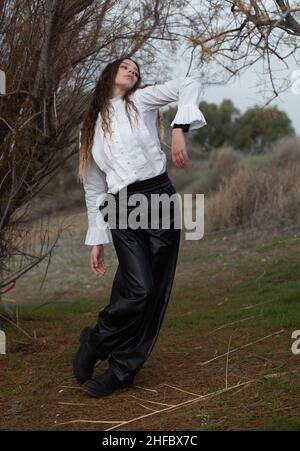 Young woman dancing outdoors. Dance performance in the street Stock Photo