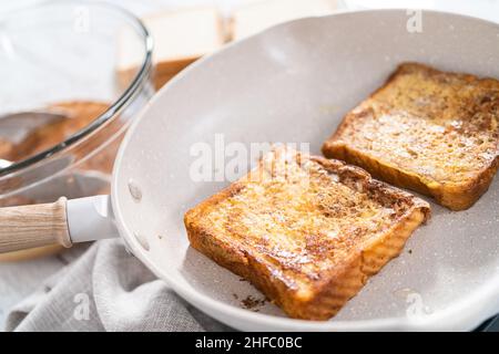 Frying french toast in a nonstick frying pan. Stock Photo