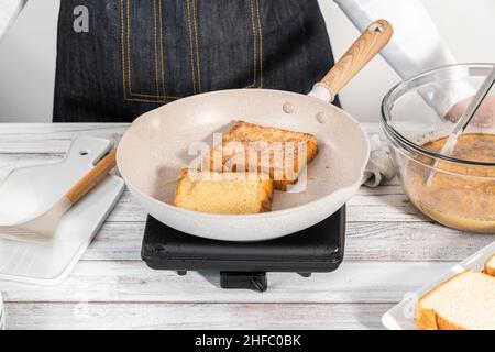 Frying french toast in a nonstick frying pan. Stock Photo