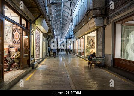 Traders in a corridor of the Carpet Bazaar in the Grand Bazaar in Tehran, Iran Stock Photo