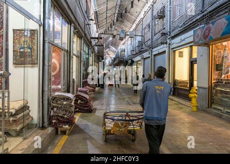 Traders in a corridor of the Carpet Bazaar in the Grand Bazaar in Tehran, Iran Stock Photo