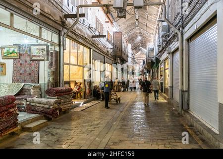 Traders in a corridor of the Carpet Bazaar in the Grand Bazaar in Tehran, Iran Stock Photo