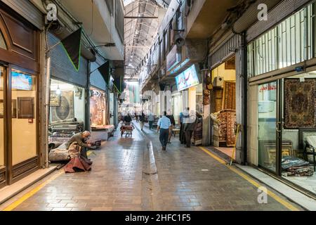 Traders in a corridor of the Carpet Bazaar in the Grand Bazaar in Tehran, Iran Stock Photo