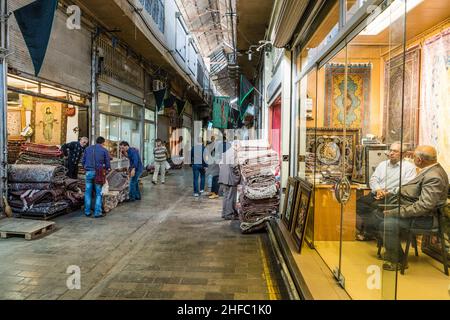 Traders in a corridor of the Carpet Bazaar in the Grand Bazaar in Tehran, Iran Stock Photo