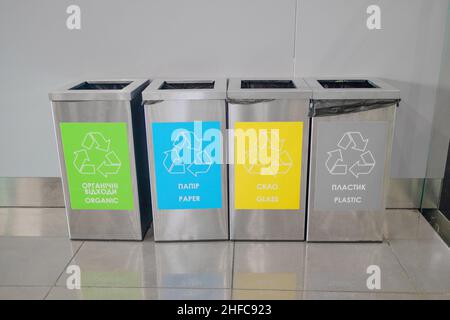 Colored rubbish containers for separate sorting of garbage. Containers for recycling various types of waste plastic, glass, paper, garbage near a Stock Photo