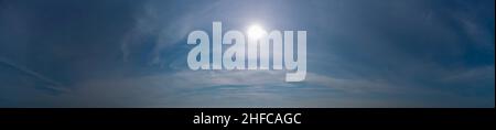 The sun shines through the cirrus clouds. Stock Photo