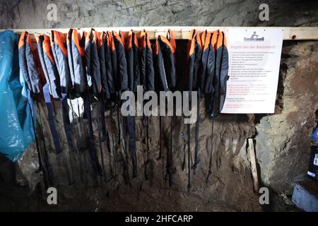 15 January 2022, Saxony-Anhalt, Wettelrode: Life jackets hang in a room in the Röhrigschacht. At 283 meters underground in the Röhrigschacht, you can not only ride the mine train and take a look on foot at how copper ore used to be mined in the Sangerhausen and Mansfeld mining districts. From now on, deep down in the mountain after the Corona loosenings, canoeing is also possible again. The canoeing fun at 1,800 meters takes visitors down a route that is about 135 years old and branches off from the normal museum area. Participants travel a total of around 1,800 meters on the special tour, whi Stock Photo