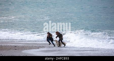 People walk alongside the beach during spring break Thursday, March 13 ...