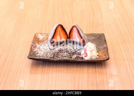 In Japan, sticky rice is known as mochigome. It is used as an ingredient in the preparation of mochi, a rice cake, this one with strawberries and crea Stock Photo