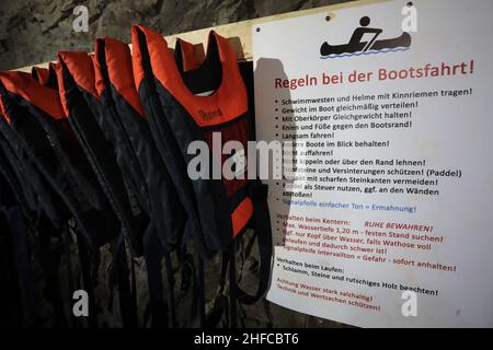 15 January 2022, Saxony-Anhalt, Wettelrode: Life jackets hang in a room in the Röhrigschacht. At 283 meters underground in the Röhrigschacht, you can not only ride the mine train and take a look on foot at how copper ore used to be mined in the Sangerhausen and Mansfeld mining districts. From now on, deep down in the mountain after the Corona loosenings, canoeing is also possible again. The canoeing fun at 1,800 meters takes visitors down a route that is about 135 years old and branches off from the normal museum area. Participants travel a total of around 1,800 meters on the special tour, whi Stock Photo