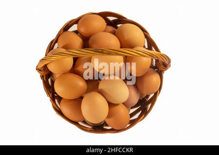Chicken eggs in basket isolated on white Stock Photo