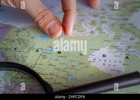 Canada pin on a world map. Canada travel destination planning pinned Stock Photo