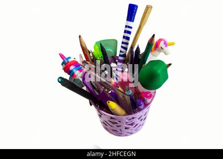 Glass with pencils and pens isolated on white. Stock Photo