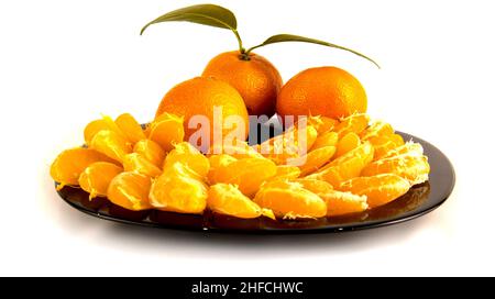 Plate with slices of tangerines isolated on white. Stock Photo