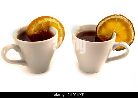 White mug with tea and dried oranges isolated on white Stock Photo