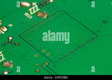 Missing electronic components on green printed circuit  board (PCB). Stock Photo