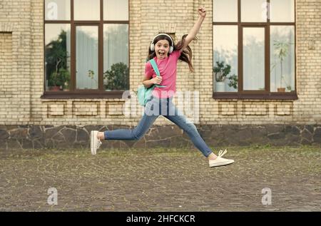 Energetic drive. Happy child in energetic jump outdoors. Energetic mood. Music and entertainment. School holidays. Summer vacation. Healthy and Stock Photo