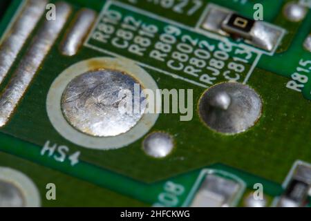 Crystallized metal solder on printed circuit board (PCB). Stock Photo