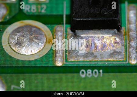 Crystallized metal solder on printed circuit board (PCB). Stock Photo