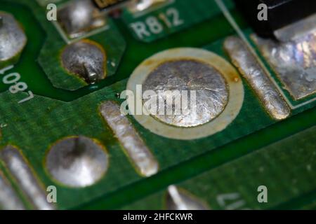 Crystallized metal solder on printed circuit board (PCB). Stock Photo