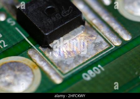 Crystallized metal solder on printed circuit board (PCB). Stock Photo