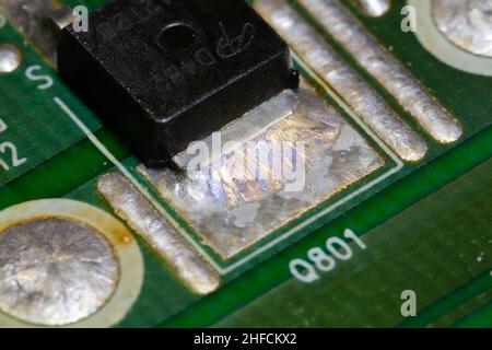 Crystallized metal solder on printed circuit board (PCB). Stock Photo