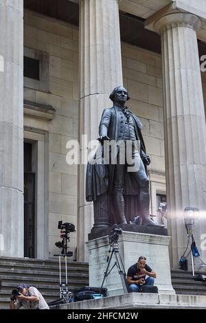 George Washington sculpture on the steps of Federal Hall in lower Manhattan. Photographers and journalists are preparing for an important event. Stock Photo