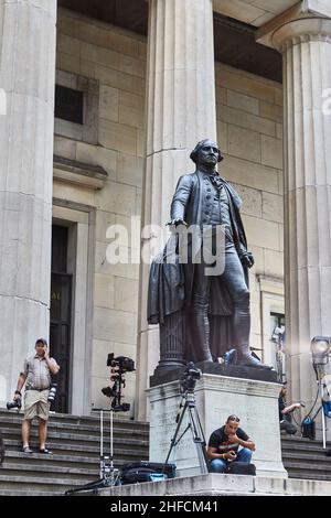 George Washington sculpture on the steps of Federal Hall in lower Manhattan. Photographers and journalists are preparing for an important event. Stock Photo