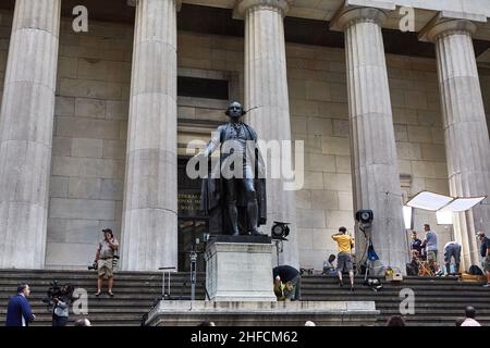 George Washington sculpture on the steps of Federal Hall in lower Manhattan. Photographers and journalists are preparing for an important event. Stock Photo