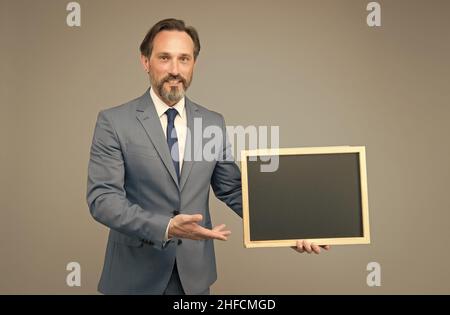 Product introduction. Businessman presenting product at blackboard. Product promotion. Product advertising. Promoting and marketing. Sale. Shopping Stock Photo