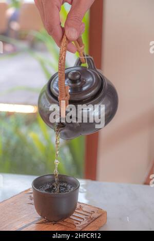 hand pour Chinese or Japanese traditional tea from clay pot Stock Photo