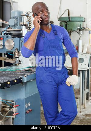 Worker talking on phone Stock Photo