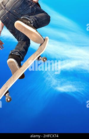 boy with skate board going airborne Stock Photo
